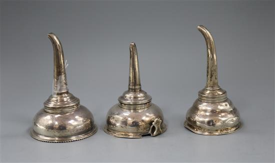 A George III silver wine funnel and two other Georgian silver wine funnels (a.f.).